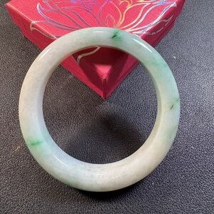Jadeite jade bangle bracelet. Type A, moss in snow. Green on white base.